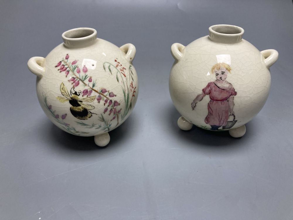 A pair of globular earthenware posy vases, height 10cm